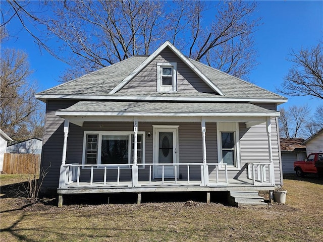 bungalow-style house featuring covered porch and a shingled roof