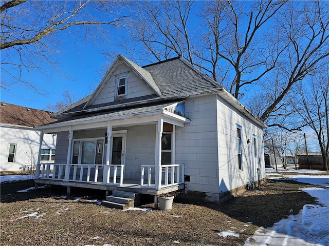 view of front of property with a porch and a shingled roof