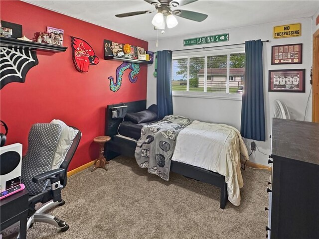 carpeted bedroom with a ceiling fan and baseboards