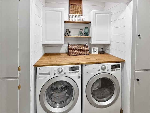 laundry room featuring washer and dryer and cabinet space