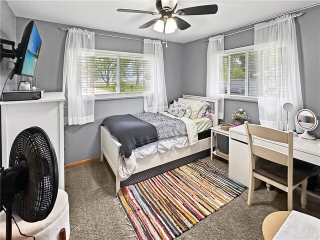 bedroom with carpet, multiple windows, ceiling fan, and baseboards