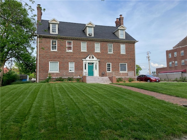 colonial-style house with a front yard