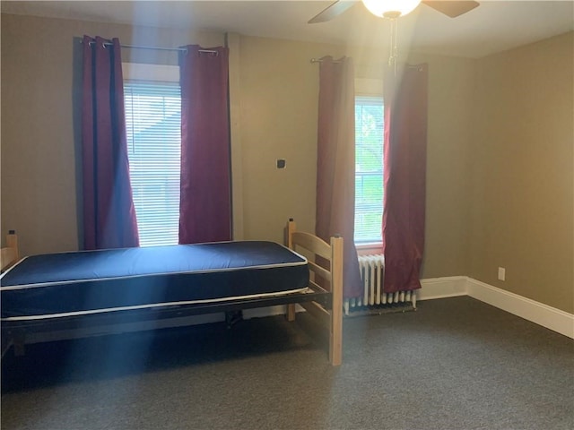 bedroom with ceiling fan and radiator