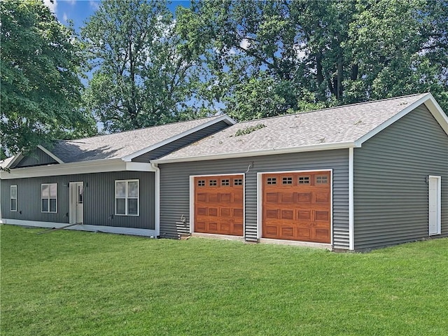 1100 Marshall Ave, Mattoon, IL 61938 - view of front of property featuring a garage, a shingled roof, and a front lawn