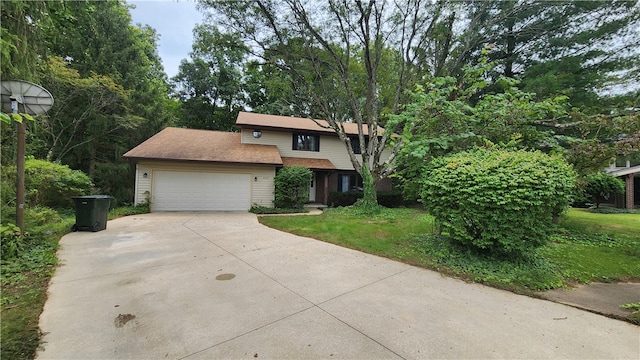 view of front of home featuring a garage and a front lawn