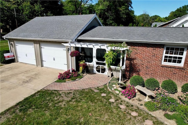 exterior space featuring a garage and a front lawn