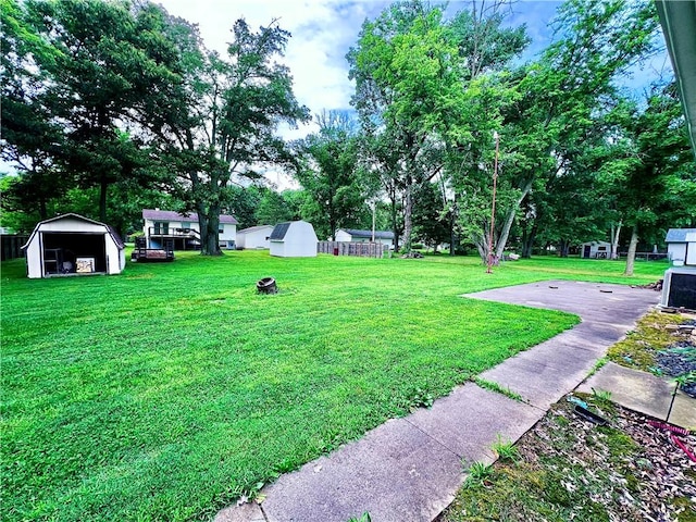 100 Chaparral St, Watson, IL 62473 - view of grassy yard featuring a storage shed