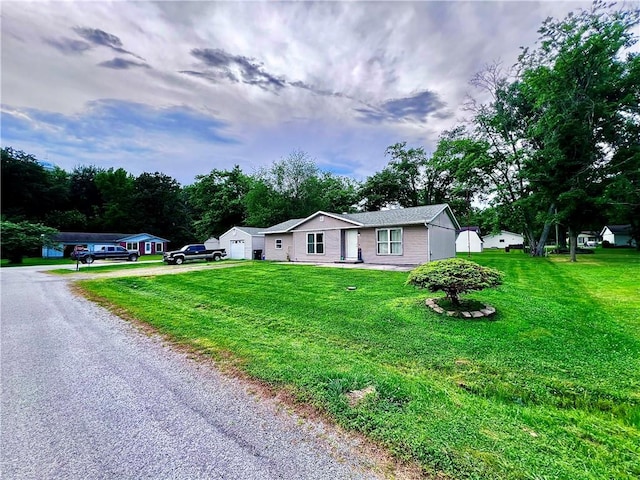 100 Chaparral St, Watson, IL 62473 - ranch-style home with driveway, a front lawn, and a detached garage