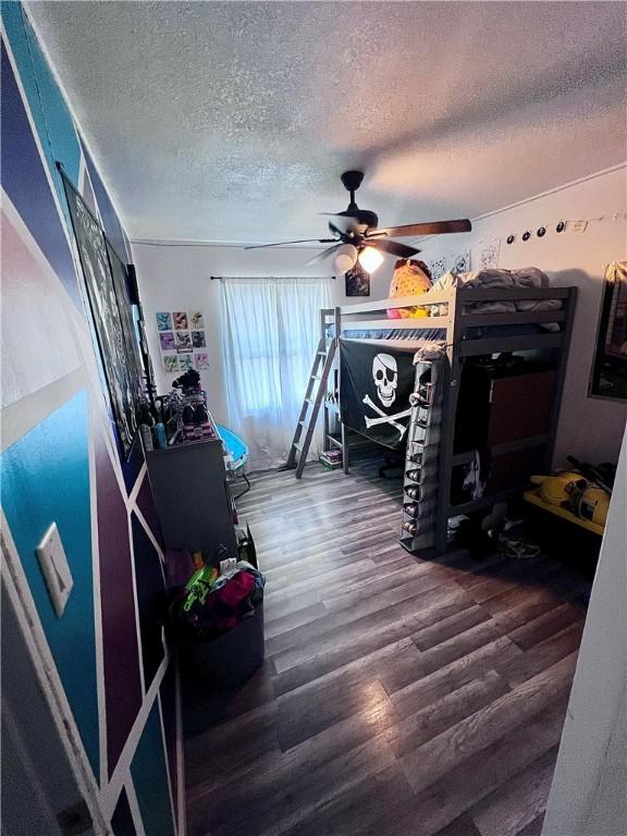 100 Chaparral St, Watson, IL 62473 - bedroom featuring a textured ceiling, wood finished floors, and ceiling fan