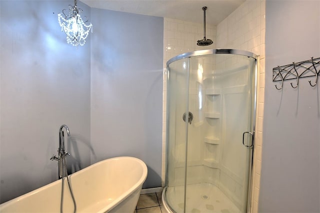 bathroom with tile patterned floors and independent shower and bath