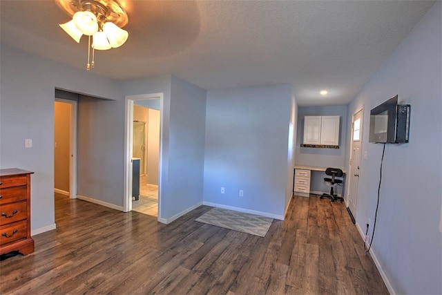 spare room featuring a textured ceiling, ceiling fan, and dark hardwood / wood-style floors