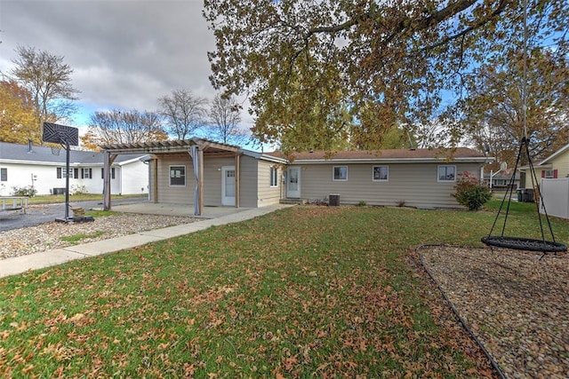 back of property with a pergola, a yard, and central AC unit