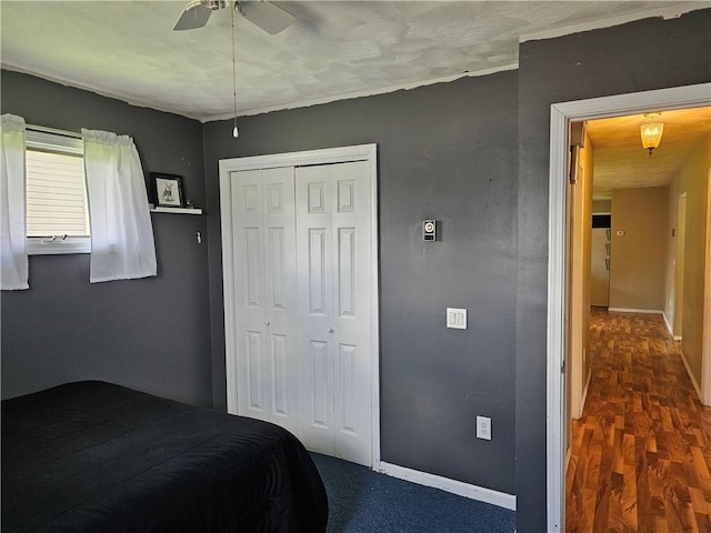 201 N Indiana St, Toledo, IL 62468 - bedroom featuring a closet, baseboards, dark wood-style floors, and ceiling fan
