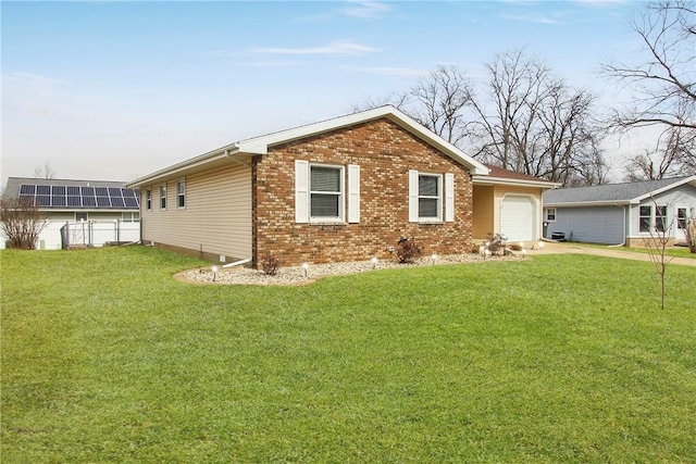 ranch-style home featuring concrete driveway, a front lawn, an attached garage, and brick siding