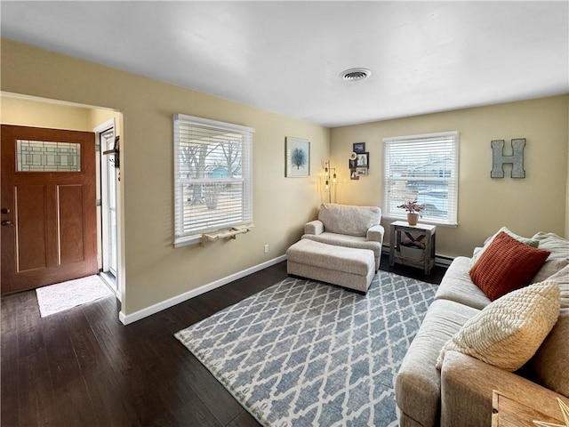 living area featuring baseboards, visible vents, and dark wood-style flooring