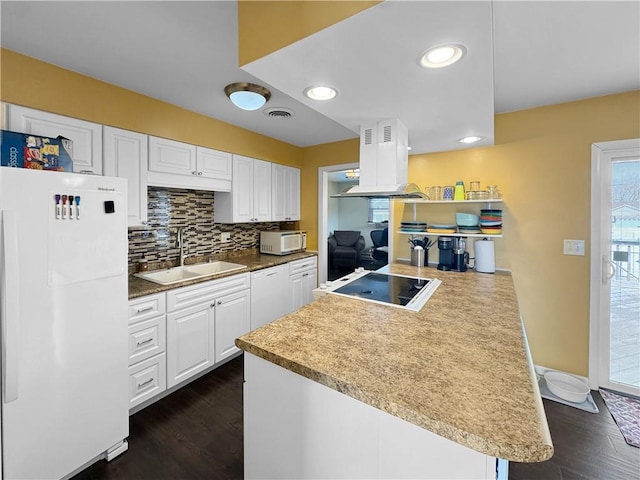 kitchen featuring white appliances, a sink, white cabinets, backsplash, and island exhaust hood