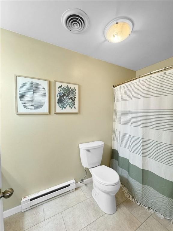 bathroom with visible vents, baseboards, toilet, a baseboard radiator, and tile patterned floors