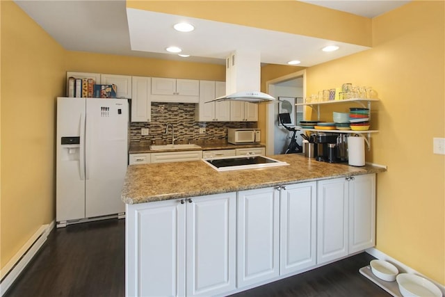 kitchen featuring white appliances, island range hood, a peninsula, baseboard heating, and a sink