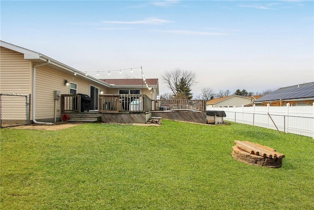 view of yard with fence and a wooden deck