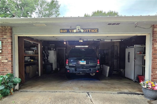 3254 Vista Dr, Danville, IL 61832 - garage featuring driveway and freestanding refrigerator
