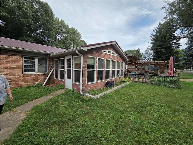 3254 Vista Dr, Danville, IL 61832 - back of house featuring a lawn, brick siding, a deck, and a metal roof
