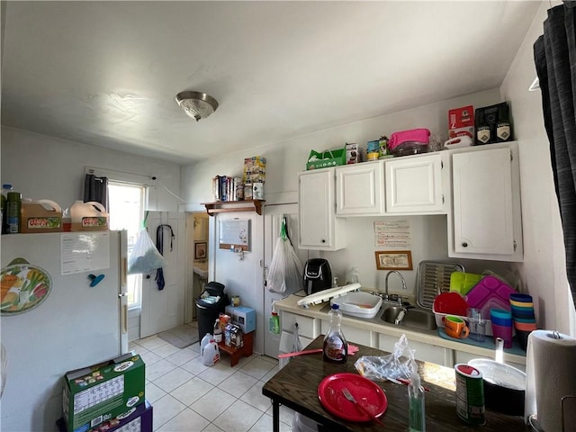 303 6th St, Charleston, IL 61920 - kitchen with light tile patterned floors, white fridge, and white cabinets