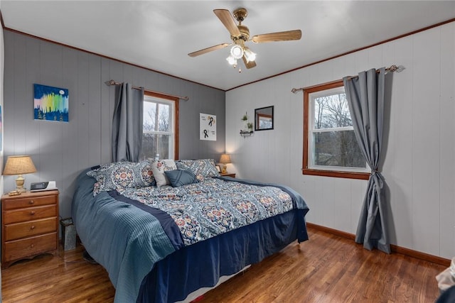 bedroom featuring ceiling fan, wood-type flooring, and ornamental molding