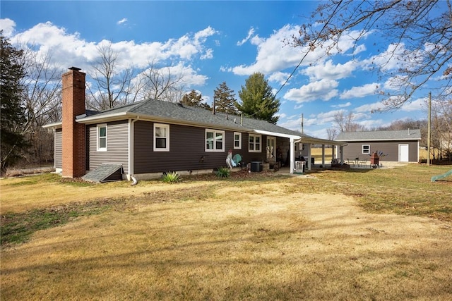 back of property with a patio, central AC unit, and a lawn