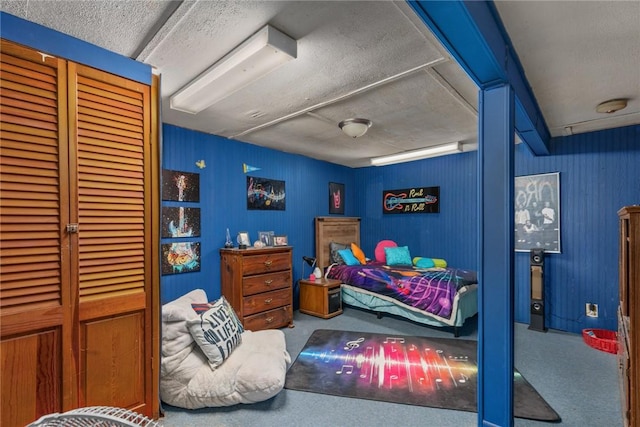 bedroom with a closet, a textured ceiling, and carpet