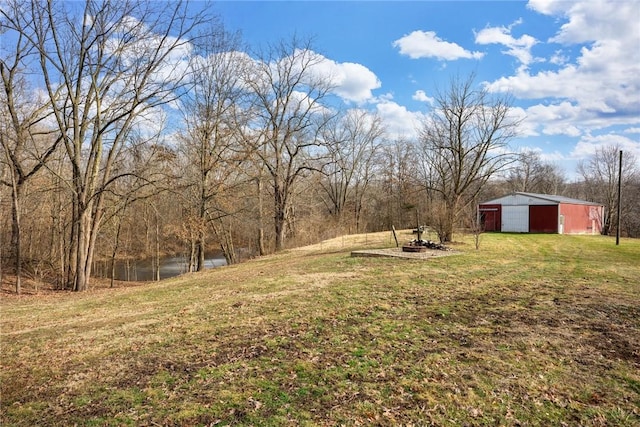 view of yard featuring an outbuilding and a water view