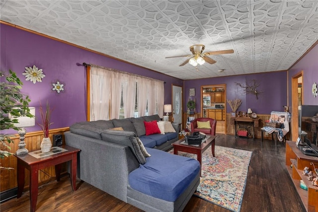 living room with dark wood-type flooring and ceiling fan