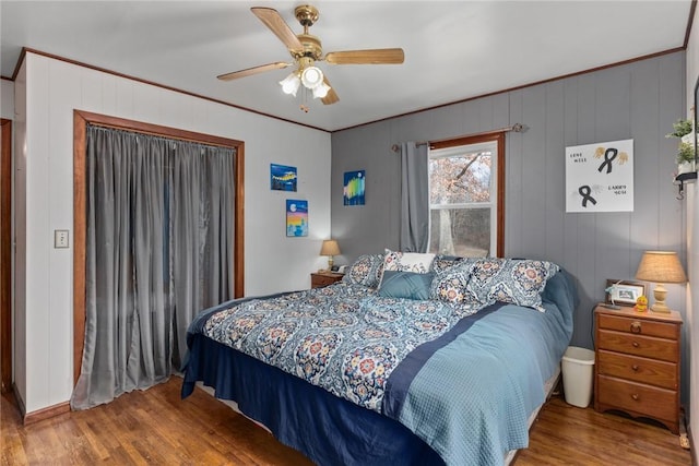 bedroom featuring crown molding, ceiling fan, and hardwood / wood-style floors