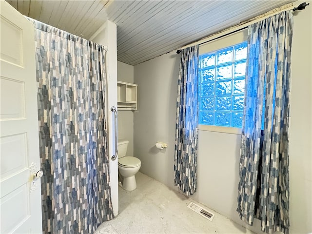 bathroom featuring concrete flooring and toilet