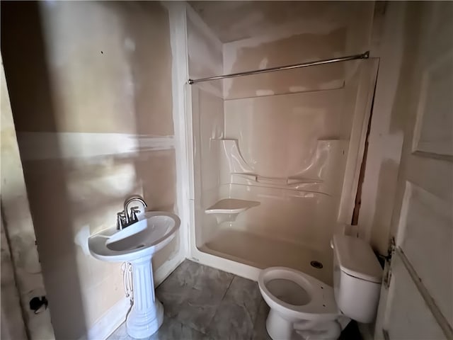 bathroom featuring toilet and walk in shower