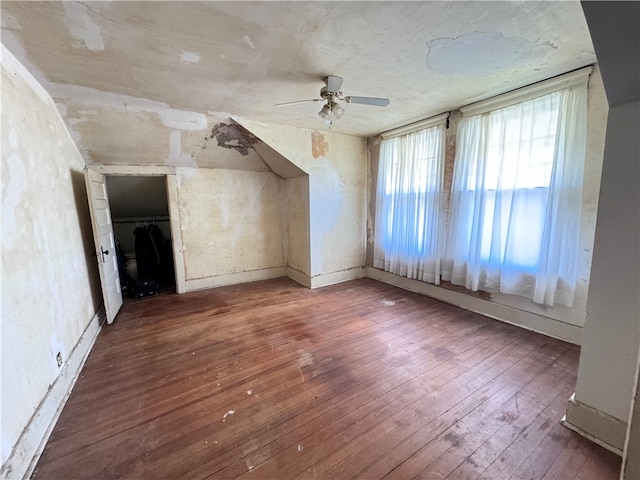 additional living space featuring hardwood / wood-style floors, ceiling fan, and vaulted ceiling