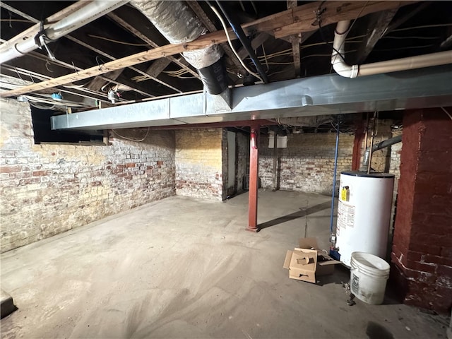 basement with water heater and brick wall