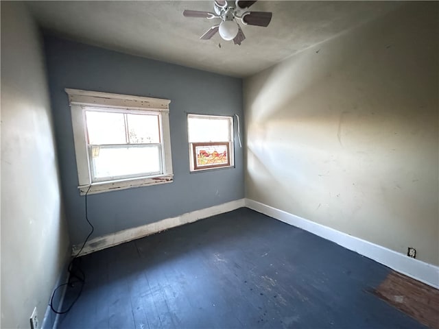 spare room with ceiling fan and dark hardwood / wood-style floors