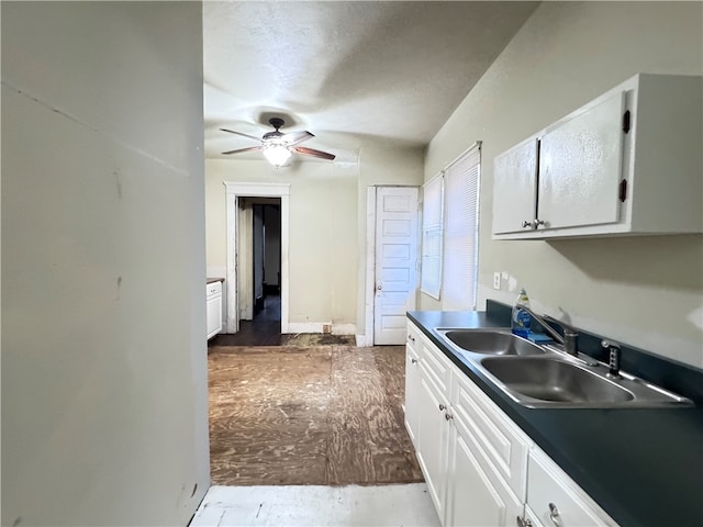 kitchen with white cabinets, ceiling fan, sink, and hardwood / wood-style flooring