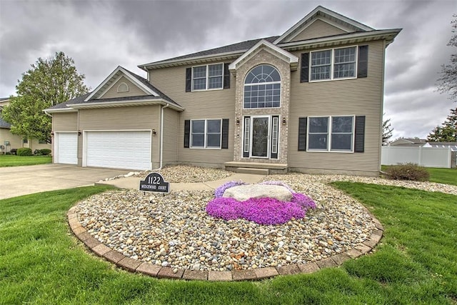 view of front of home featuring an attached garage, a front lawn, and concrete driveway