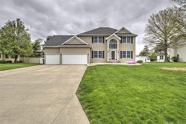 view of front facade with a garage, driveway, and a front yard