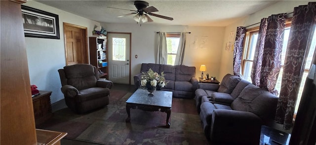 living room featuring a textured ceiling and a ceiling fan