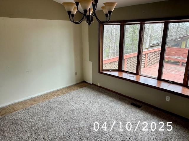 6680 John Dr, Mt Zion, IL 62549 - empty room featuring a chandelier and carpet