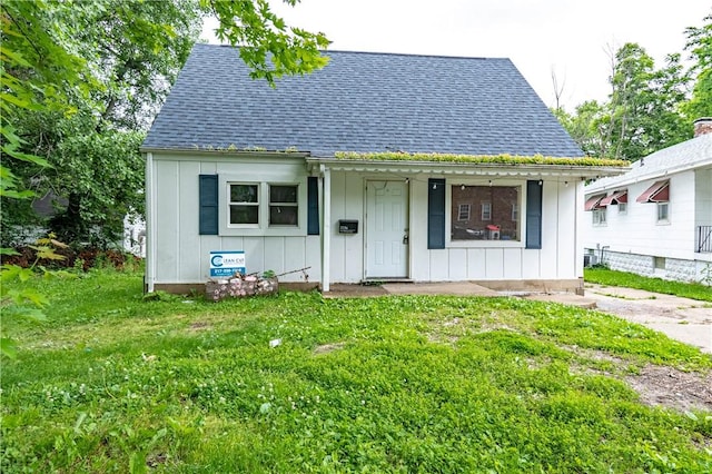2036 E Dickinson Ave, Decatur, IL 62521 - bungalow-style home featuring board and batten siding, roof with shingles, a front yard, and covered porch