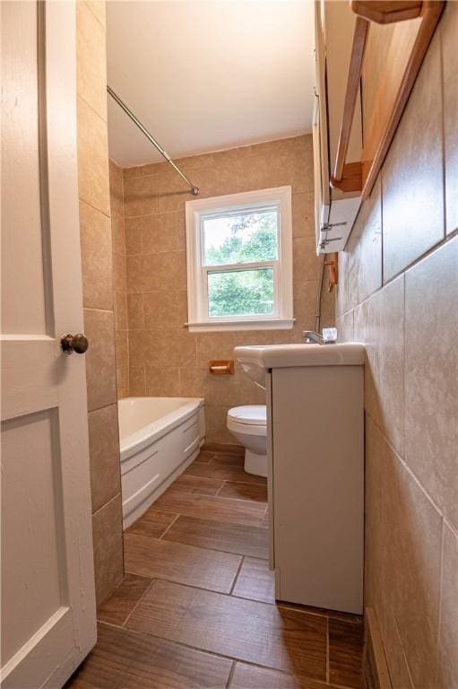2036 E Dickinson Ave, Decatur, IL 62521 - bathroom featuring tile walls, shower / bath combination, wood finished floors, and vanity