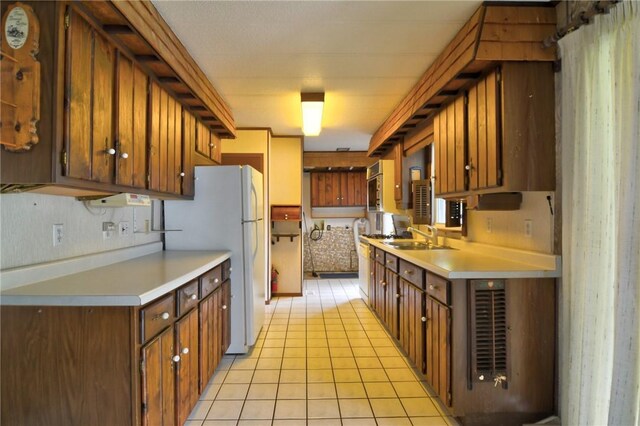 707 S Airport Rd, Decatur, IL 62521 - kitchen with light countertops, light tile patterned floors, and freestanding refrigerator