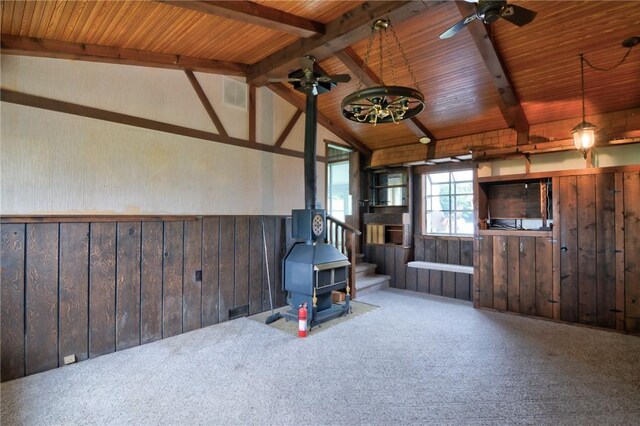 707 S Airport Rd, Decatur, IL 62521 - living area featuring a wood stove, a wainscoted wall, wooden ceiling, carpet flooring, and wood walls