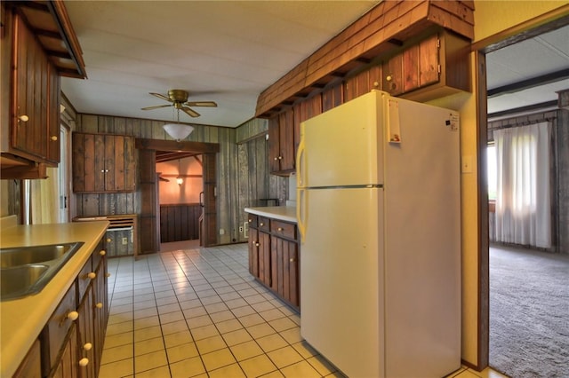 707 S Airport Rd, Decatur, IL 62521 - kitchen featuring freestanding refrigerator, ceiling fan, light countertops, wood walls, and light tile patterned floors