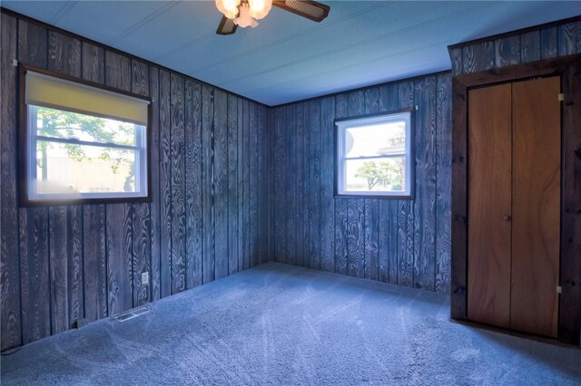 707 S Airport Rd, Decatur, IL 62521 - unfurnished bedroom featuring carpet, multiple windows, and a ceiling fan