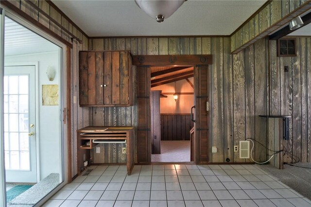 707 S Airport Rd, Decatur, IL 62521 - kitchen featuring wood walls and light tile patterned floors