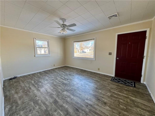 foyer featuring ornamental molding, visible vents, dark wood finished floors, and baseboards